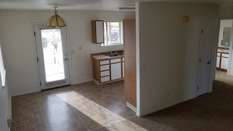 The image shows a door next to the kitchen to exit the apartment